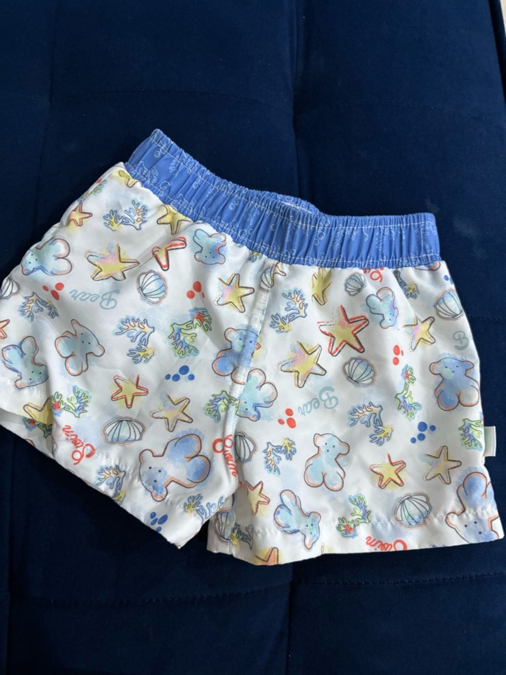 Tous Kids White Swim Shorts with Blue Waistband and Pastel Sea Creatures
